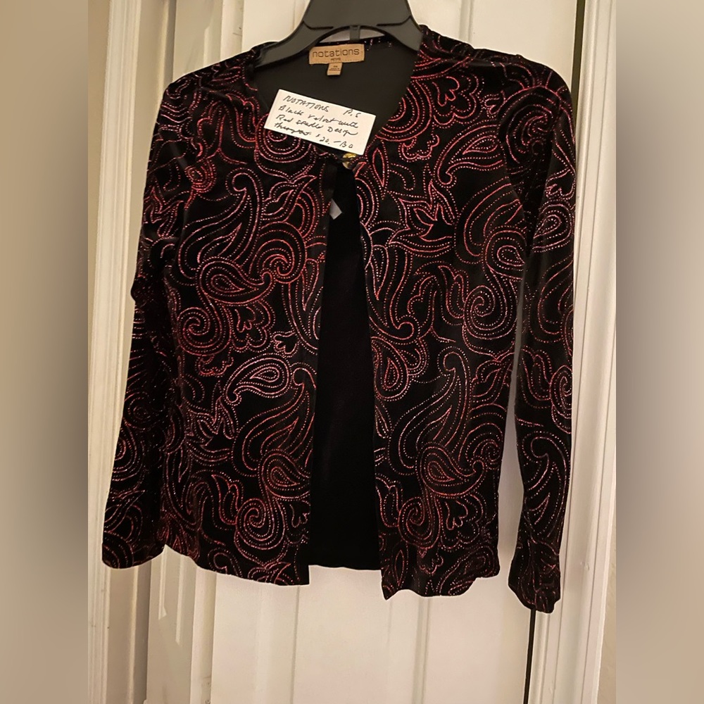 Black with red shinny design. Feels like velvet jacket size small